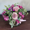 A delightful posey vase filled with fresh seasonal greenery, roses and alstroemeria