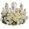 Peaceful and majestic, a graceful angel rests amongst fragrant, snow white roses