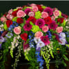 Colorful and bright, hot pink gerbera, green hydrangea, red and pink roses