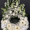 Cremation ring, white larkspur, snapdragons, roses, Gerber, and filler