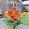 An attention seeking blend of novelty Carnations, yellow Lilies, Lavender Stock with