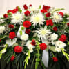 Red and white casket spray made with Roses, Carnations, Glads, Bells of