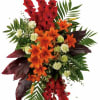 Artistic standing spray made with Glads, Lilies, Carnations and Exotic foliage.