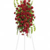 Ruby red standing spray made with Roses, Carnations and Bells of Ireland.