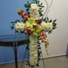 A cross made out of mum , dendro orchid, outlined with italian