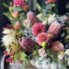 The presence of protea in the flower arrangements truly adds a special