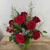The Forest Whisper bouquet features delicate roses cradled in a rounded glass