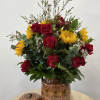 &ldquo;Encanto De Barro&rdquo; charming arrangement of red roses, vibrant, sunflowers, and lush