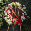 A red and white standing funeral wreath delivered straight to your event