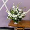 All white gladiolus (or white lilies) with regular and mini carnations arranged