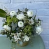 white roses, white ranunculus paired with green hydrangeas and a variety of