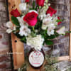 This beautiful red and white cut flower vase arrangement arrives with a