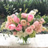 Great small desk arrangement in clear cube vase with pink shade flowers