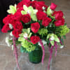 24 red roses, green orchids and hydrangeas in clear cylinder