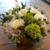 white and green tone cube arrangement with roses, hydrangeas, orchids and thistles