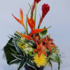 A vibrant arrangement of gingers, lilies, calla lilies, and chrysanthemums.  