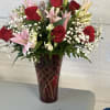 Vibrant red roses intertwine with delicate pink lilies, creating a symphony of