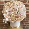 This beautiful arrangement filled with creamy blooms, 50 Roses and orchids is