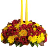 Happy yellow mums and a taper candle bring sunshine to your Thanksgiving