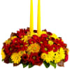 Happy yellow mums and a taper candle bring sunshine to your Thanksgiving