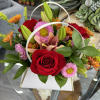 &quot;An elegant blend of red roses, pink lilies, and orange daisies beautifully