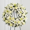 All white wreath made with assorted white flowers.