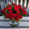 A romantic collection of beautiful red roses with additional red accented flowers