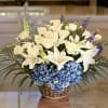 A blue, white, and green funeral basket for any type of service.