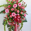 This glorious spray includes , light pink snap , pink carnations, miniature