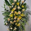 The standing spray funeral arrangement exudes a sense of serenity and beauty