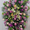 The elegant standing spray funeral arrangement radiates a sense of tranquility and