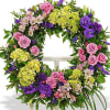 Mixed pastel colored wreath made with beautiful seasonal flowers.