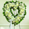 All White Hollow Heart made with Carnations, Roses, Lilies, Carnations and fillers.