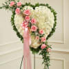 Pink and white heart made with Carnations and Roses.