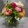 This autumn bouquet in a pumpkin vase combines warm-toned roses, chrysanthemums, and