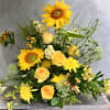 A summer arrangement suitable for a sympathy service.  This one sided
