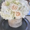 White hydrangeas and ivory roses in a beautiful birch bark vase.