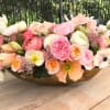 This beautiful arrangement is in a golden vase with a wide variety