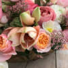 This beautiful arrangement is in a golden vase with a wide variety