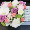 mix flowers with rolls of bill in box