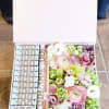 mix flowers with rolls of bill in box