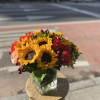 A beautiful sunflower and rose arrangement. The perfect gift to brighten up