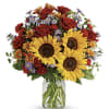A sunny sunflower bouquet gets an autumnal spin with the addition of