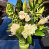 Designed with white roses, hydrangea, bells of Ireland, white lilies, variegated aspidistras