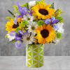 Bright yellow sunflowers, blue iris, white daisies, combined with yellow solidago, green