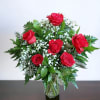 A beautiful bouquet of premium red roses and lush greens, presented in