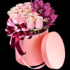 A modern petite flower arrangement in a cylinder box filled with pink