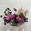 Elegant floral arrangement with vibrant pink dahlias, lavender roses, and deep purple