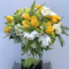 A refreshing arrangement full of yellow roses, tulips, hydrangeas, and orchids...a perfect