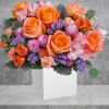 Cheerful as can be, this whimsical arrangement of orange and peach blooms